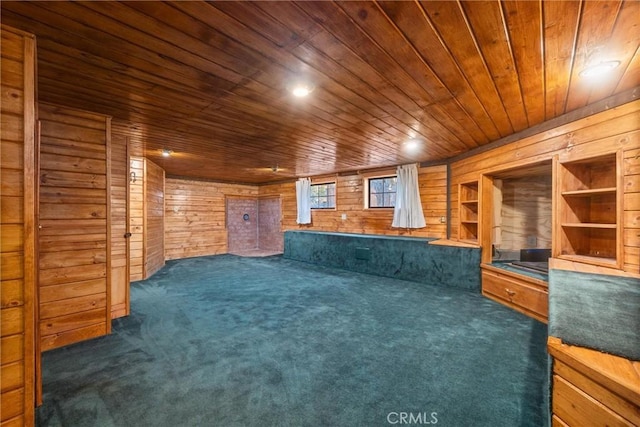 interior space featuring wooden ceiling, wood walls, and dark colored carpet