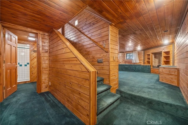 stairs featuring wood walls, wood ceiling, and carpet floors