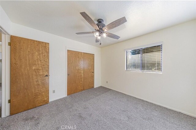 unfurnished bedroom with carpet flooring and ceiling fan