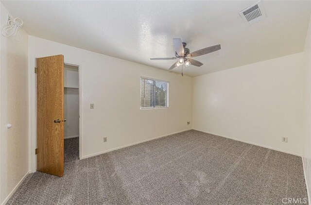 empty room featuring ceiling fan and carpet floors