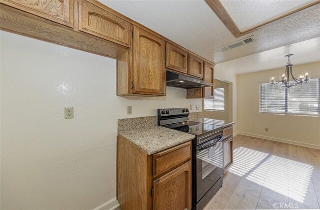 kitchen with a chandelier, light hardwood / wood-style flooring, black electric range oven, and hanging light fixtures