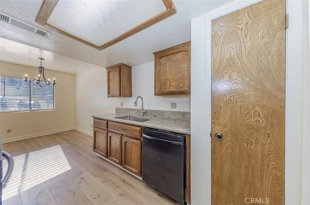 kitchen featuring dishwasher, sink, decorative light fixtures, light wood-type flooring, and a notable chandelier