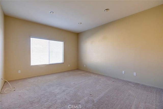 unfurnished room with light colored carpet