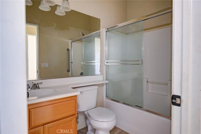 full bathroom featuring vanity, toilet, and combined bath / shower with glass door