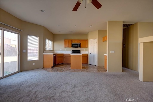 kitchen with black range, dishwasher, ceiling fan, and light carpet