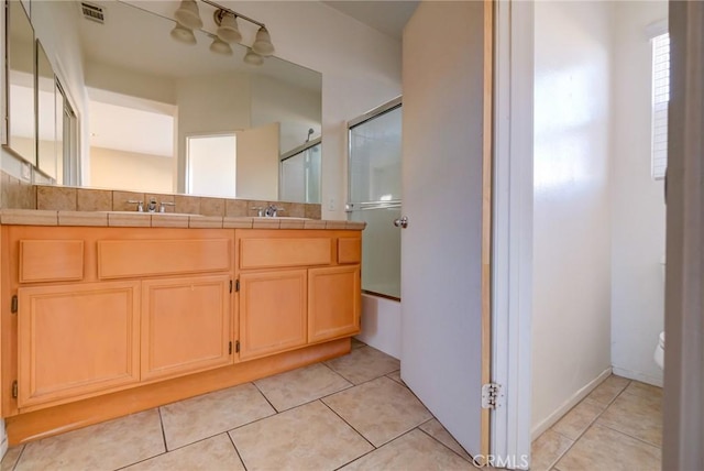 bathroom featuring toilet, vanity, and tile patterned floors