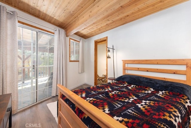 bedroom with multiple windows, beamed ceiling, wood ceiling, and hardwood / wood-style flooring