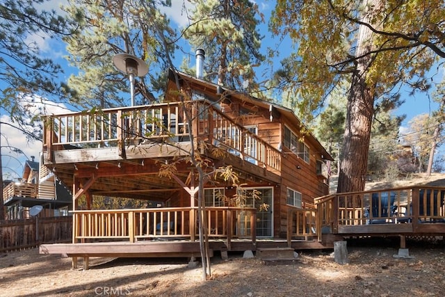 rear view of house featuring a deck