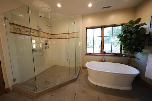 bathroom with tile patterned floors and separate shower and tub