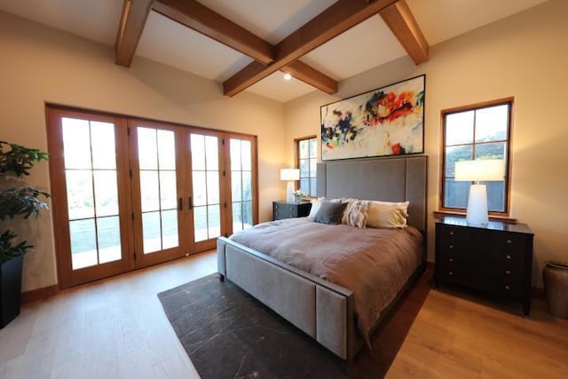 bedroom featuring access to exterior, hardwood / wood-style flooring, and multiple windows