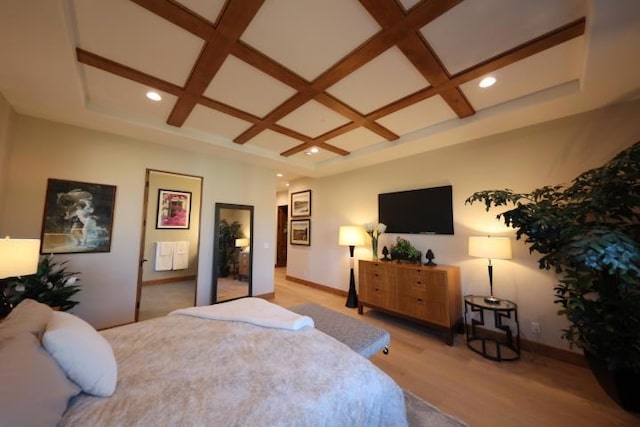 bedroom featuring beam ceiling, coffered ceiling, and light wood-type flooring