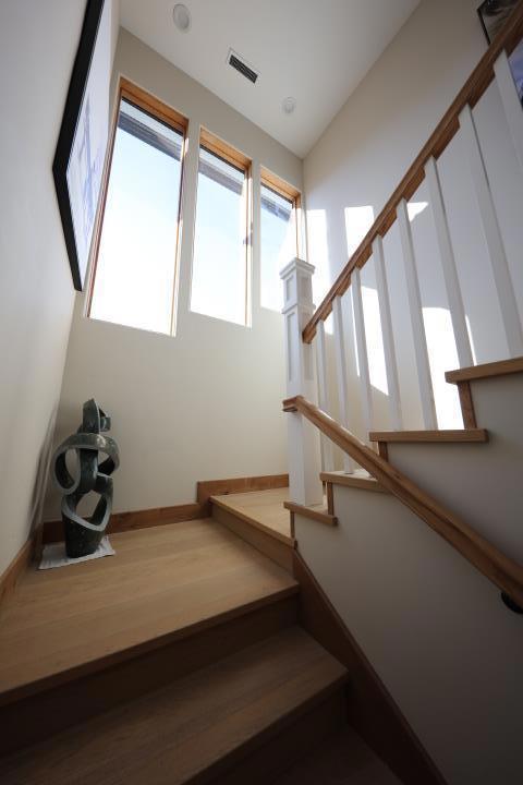 staircase featuring lofted ceiling