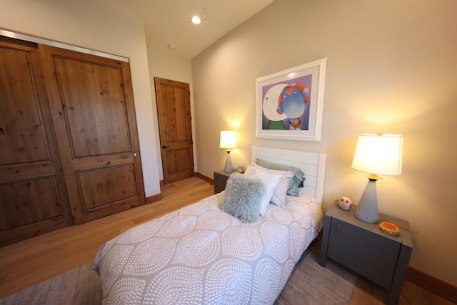 bedroom featuring light hardwood / wood-style floors and a closet