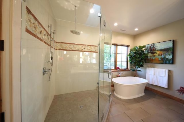 bathroom featuring tile patterned flooring and shower with separate bathtub