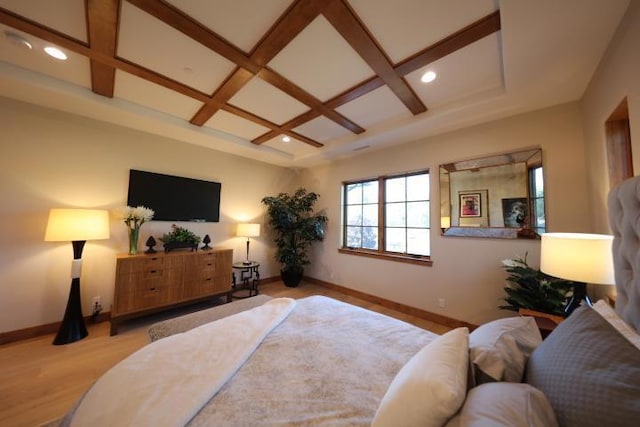 bedroom with beam ceiling, light hardwood / wood-style floors, and coffered ceiling