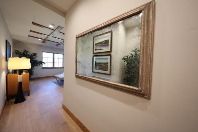 hall with beamed ceiling, wood-type flooring, and coffered ceiling