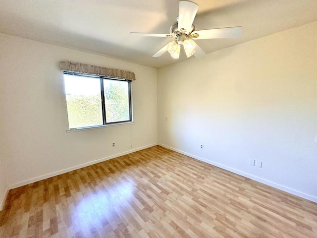 empty room with light wood-type flooring and ceiling fan