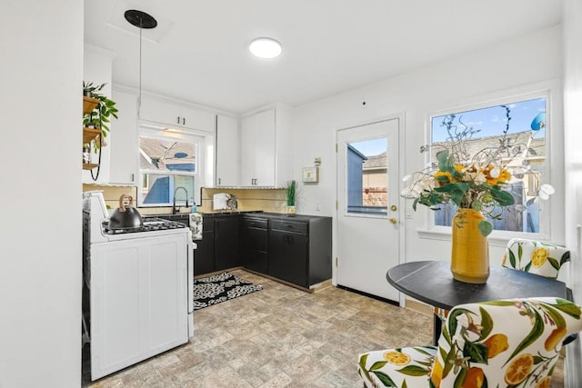 kitchen featuring decorative light fixtures, white cabinets, sink, and white range with gas cooktop