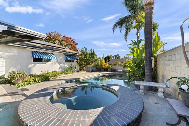 view of swimming pool with an in ground hot tub