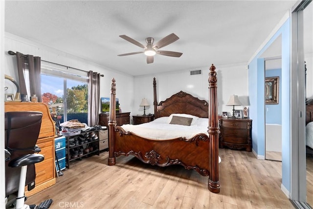 bedroom with ceiling fan, ornamental molding, and light wood-type flooring