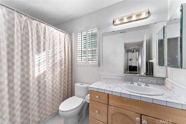 bathroom featuring a shower with curtain, tile patterned flooring, vanity, and toilet