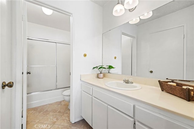 full bathroom with vanity, toilet, and shower / bath combination with glass door