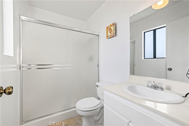 bathroom with tile patterned flooring, vanity, toilet, and walk in shower