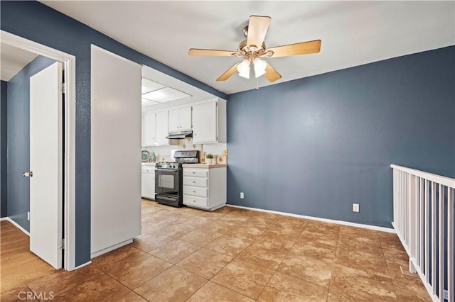 kitchen with black gas range, white cabinetry, and ceiling fan