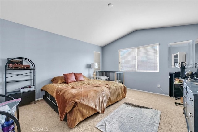 carpeted bedroom with lofted ceiling