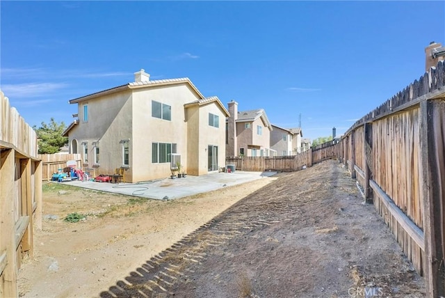 back of house with a patio