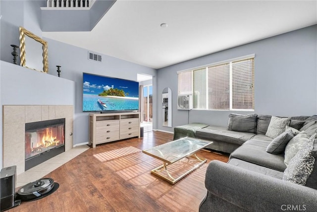 living room featuring hardwood / wood-style flooring and a fireplace