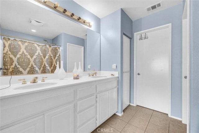 bathroom featuring tile patterned flooring and vanity