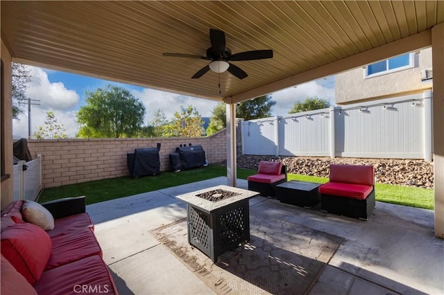 view of patio featuring ceiling fan, a grill, and an outdoor living space with a fire pit