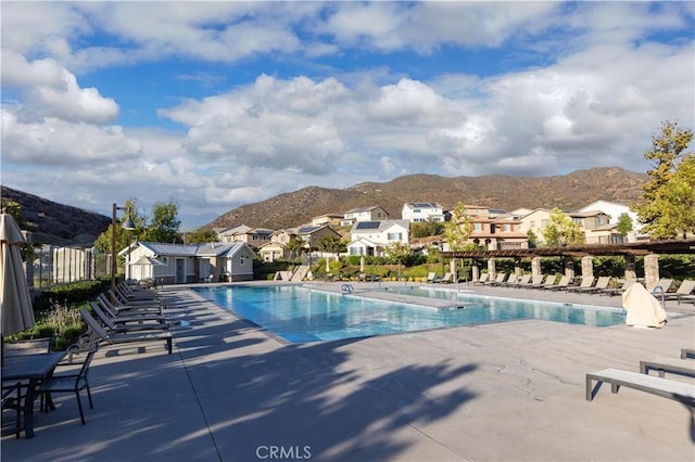 view of swimming pool with a mountain view and a patio