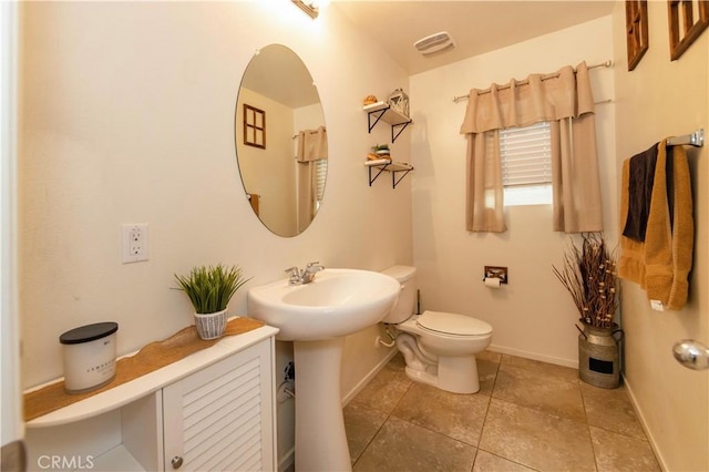 bathroom featuring sink, tile patterned flooring, and toilet