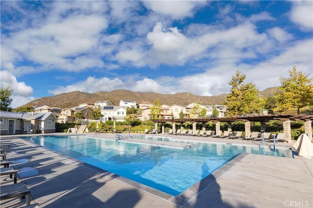 view of swimming pool featuring a mountain view and a patio area