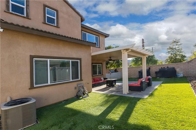 back of house with central air condition unit, a patio area, a yard, and an outdoor hangout area