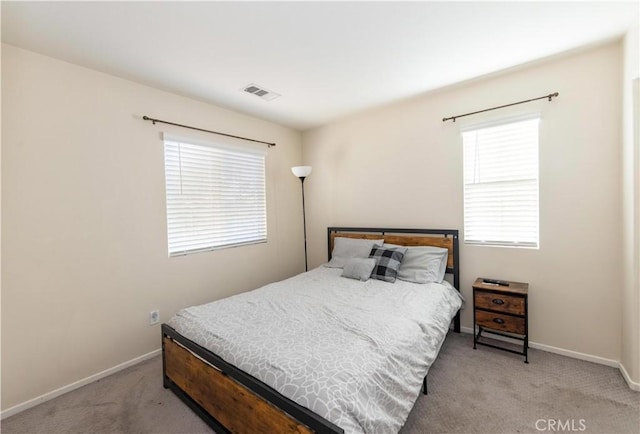 bedroom with light colored carpet