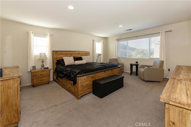 carpeted bedroom featuring multiple windows