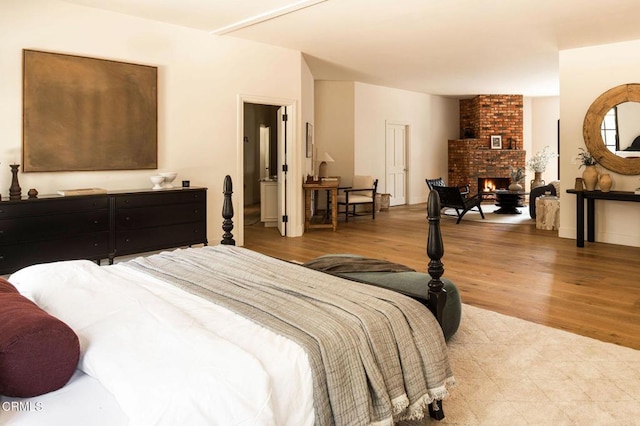 bedroom featuring a fireplace and light hardwood / wood-style floors