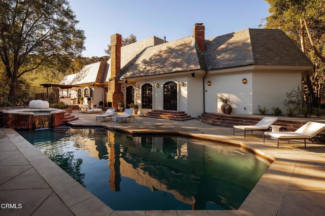 view of pool featuring an in ground hot tub and a patio