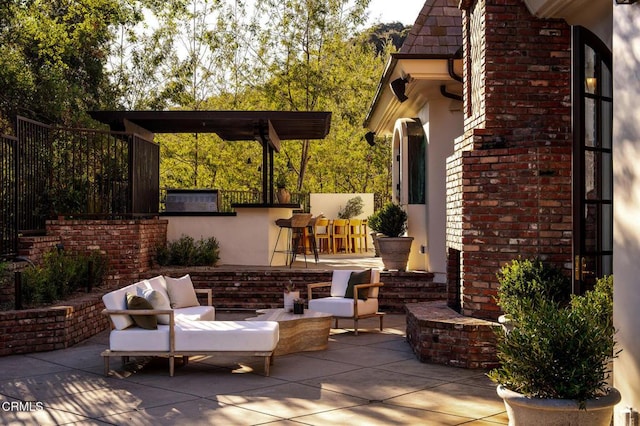 view of patio / terrace featuring outdoor lounge area, area for grilling, and exterior bar