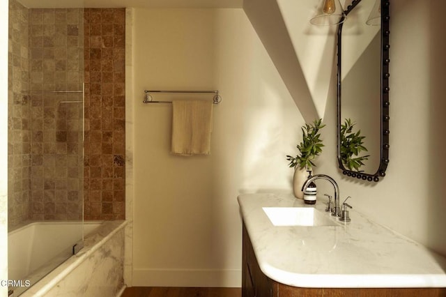 bathroom featuring vanity, tiled shower / bath combo, and hardwood / wood-style flooring