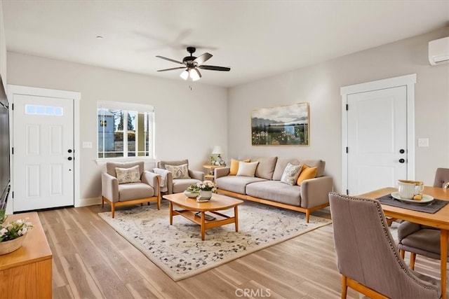 living room featuring ceiling fan and light hardwood / wood-style floors