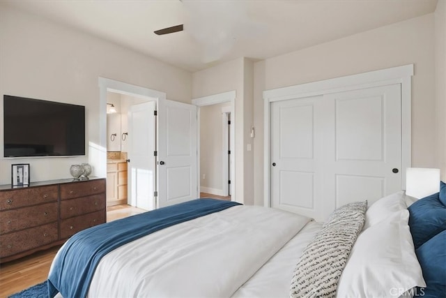 bedroom featuring ceiling fan, light wood-type flooring, and a closet