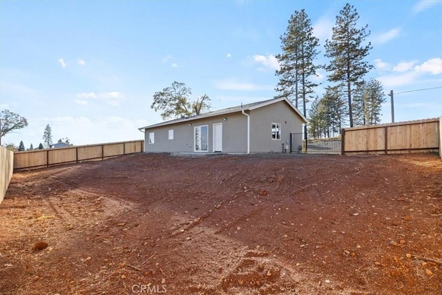 rear view of house featuring french doors