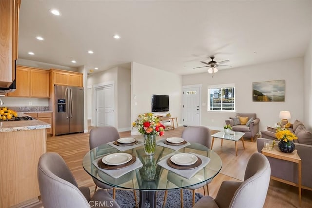 dining room featuring ceiling fan and light hardwood / wood-style flooring