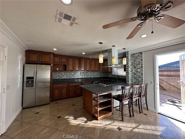 kitchen featuring hanging light fixtures, ornamental molding, kitchen peninsula, stainless steel appliances, and extractor fan