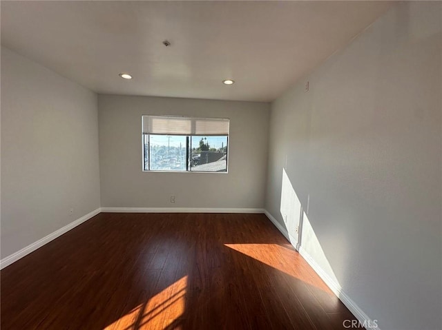 unfurnished room featuring dark wood-type flooring