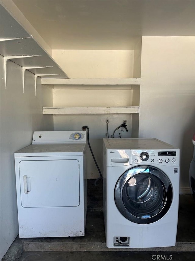 clothes washing area featuring separate washer and dryer